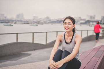 Sports concept. Beautiful girl is exercising on the beach with warm up. Beautiful girl is happy to...