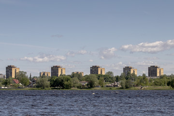 Fototapeta premium old skyscrapers close to river. Old style buildings under blue sky