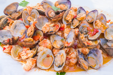 clams and prawns in a tomato sauce with peppers and garlic