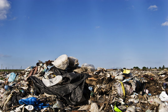 Garbage dump on the blue sky background