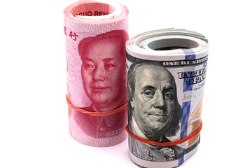 US dollar bill and Chaina yuan banknote macro white background.