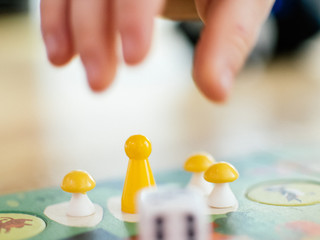 Board game baby hand stretches to take the game chip to make your move