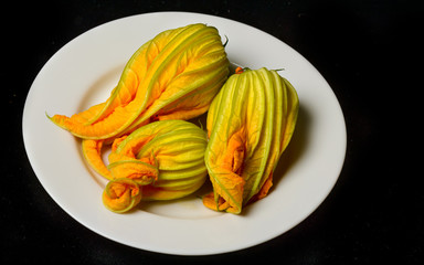 Squash blossoms on a white plate