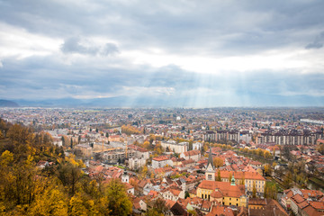 Fototapeta na wymiar View of Ljubljana city from above during overcast day with sun rays, Ljubljana, Slovenia