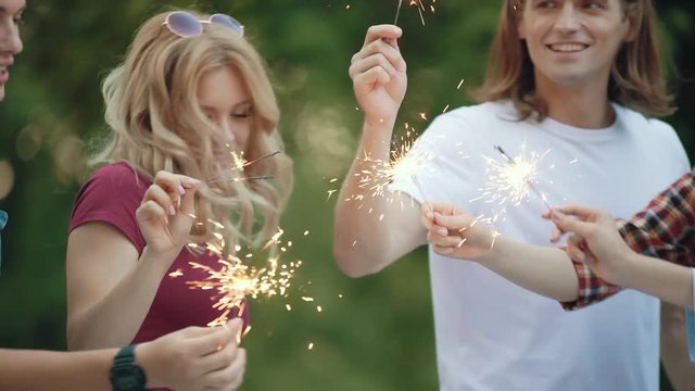 Happy Friends With Sparklers Having Fun Outdoors