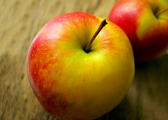 two juicy ripe apples on the background of an old wooden table close-up