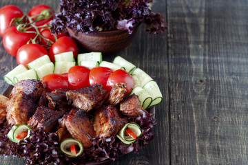 Fototapeta na wymiar Pork ribs, grilled with fresh vegetables