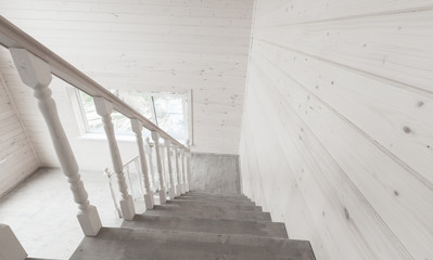 White stairway railings. Empty wooden house