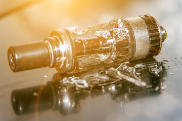Broken vaping on the table with small pieces of glass. broken glass tank