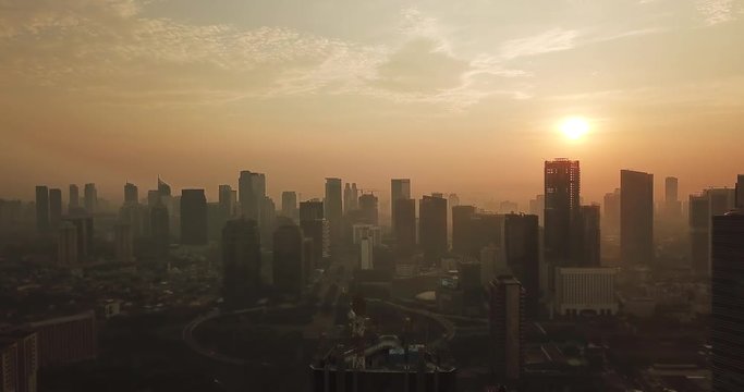 JAKARTA, Indonesia - May 22, 2018: Stunning aerial landscape of misty morning with Jakarta cityscape and skyscrapers background circa Semanggi CBD. Shot in 4k resolution
