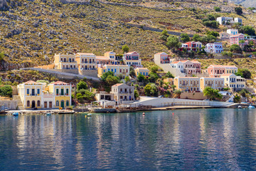 Fototapeta na wymiar Colorful houses on the hillside of the island of symi. Greece