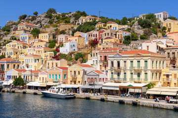 Fototapeta na wymiar Colorful houses on the hillside of the island of symi. Greece