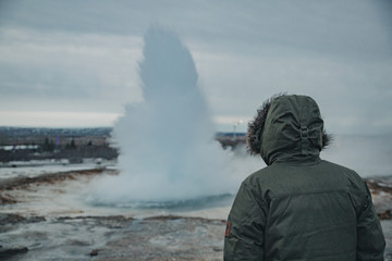 Man with hood backwards in Geysir National Park in Iceland