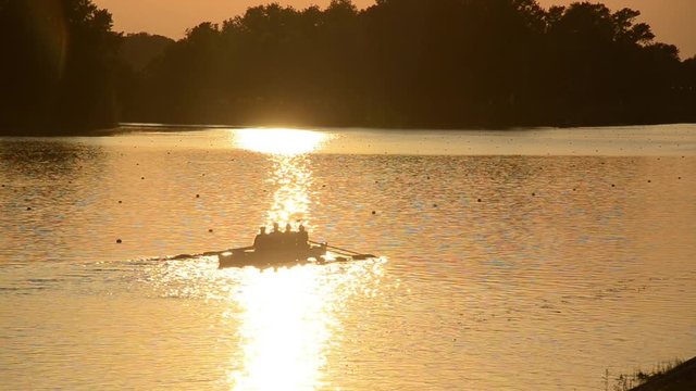 Jarun lake near Zagreb, Croatia. Sport and recreation. Rowing, kayak and canoe. Rowing team training at sunset