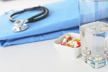 Stethoscope on a table with medical uniform