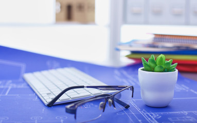 Workplace with notebook laptop Comfortable work table in office windows and city view