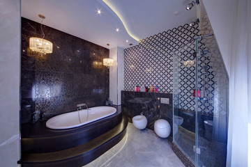 A white bathroom at dark steps with candles