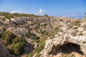 Fototapeta na wymiar Mosta, Malta. The picturesque canyon and fortifications of the Victoria Line