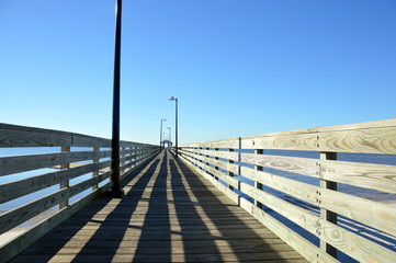 Fototapeta premium Pier leading into a cloudless sky