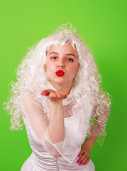 beautiful young girl with curly hairstyle. A gorgeous princess in a vintage dress and glowing white long hair. the heroine of the fairy-tale film. Air kiss.