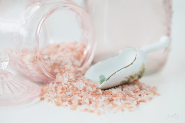 Photograph of Pink Himalayan Sea Salt Salt with pink glass on white 