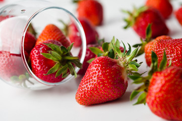 scattered strawberries on a white background