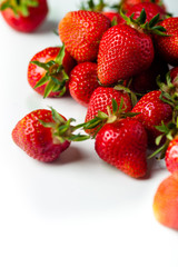 scattered strawberries on a white background