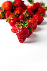 scattered strawberries on a white background
