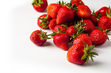 scattered strawberries on a white background