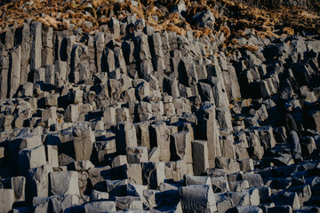 A rock formation at a cliff at Reinsfjara Beach in Iceland