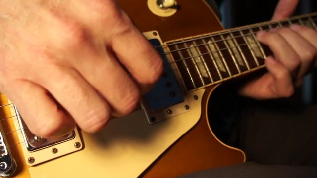 Man's hands playing electric guitar 2
