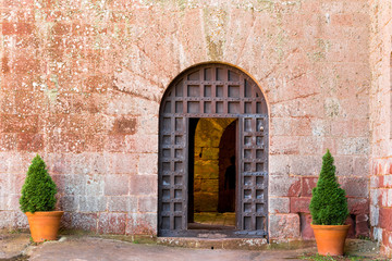 Fototapeta na wymiar View of the old iron door of the monastery Escornalbou in Tarragona, Spain. Copy space for text.
