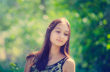 Portrait of a beautiful young girl with long hair. Toning in the style of instagram.