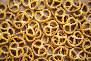 Salt pretzels on white wooden background, top view.