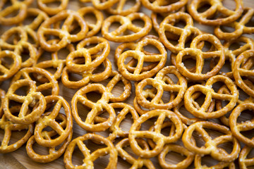 Salt pretzels on on white wooden background, closeup.
