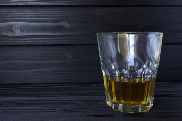 a glass with alcohol on a dark background
