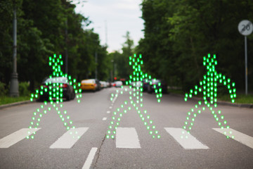 Green people walking pedestrian crossing
