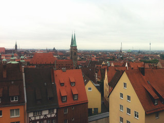 Obraz premium View from the height of the European city. Germany view of the red roofs of buildings of old Europe. Photo in cloudy weather
