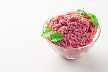 Raw minced meat in a plate on white background