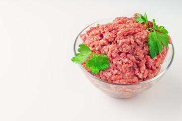 Raw minced meat in a plate on white background