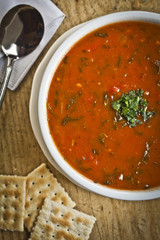 Tomato Soup with Garnish on Wooden Board