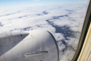 Fototapeta na wymiar Airplane turbine at the window in the sky