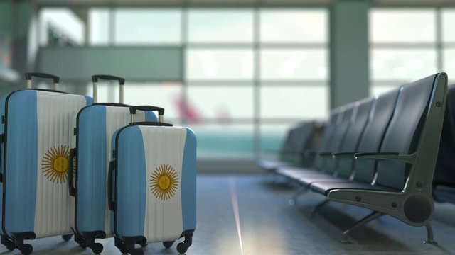 Travel suitcases featuring flag of Argentina. Argentinian tourism conceptual animation