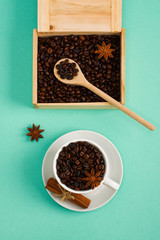 Wooden box and spoon with coffee seeds сup of coffee