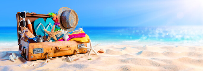 Beach Preparation - Accessories In Suitcase On Sand
