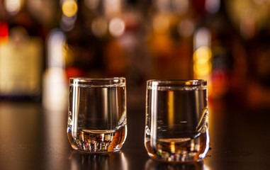 Traditional pure vodka in glasses on a black background, chilled drink