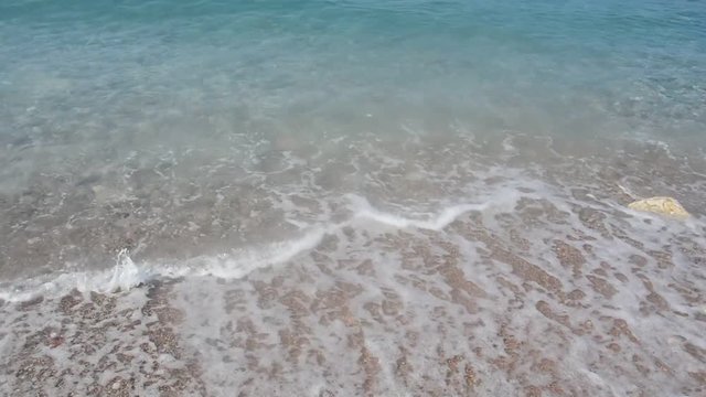 Grainy sand tropical beach, blue ocean sea wave washes the shore. Montenegro beach