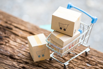 Idea of shopping online and service / e-commerce concept. Stack boxes on laptop for Customer can...