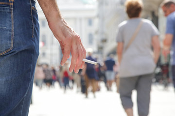 
Close up image of young man smoking a cigarette on the street