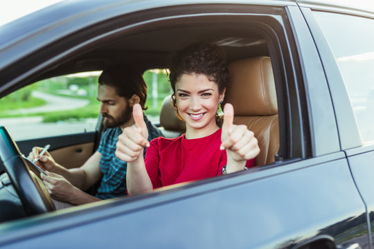 Driving school. Beautiful happy young woman successfully passed driving school test.